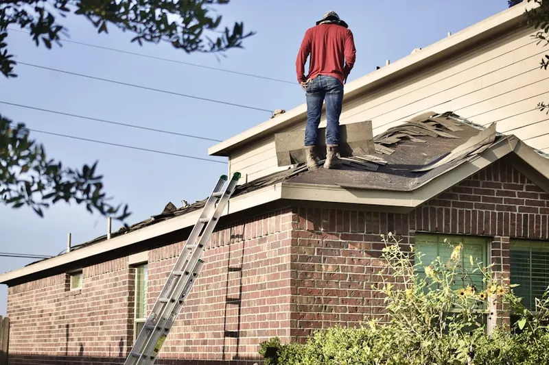 Professional roofer working on a residential roof in Ventura Village